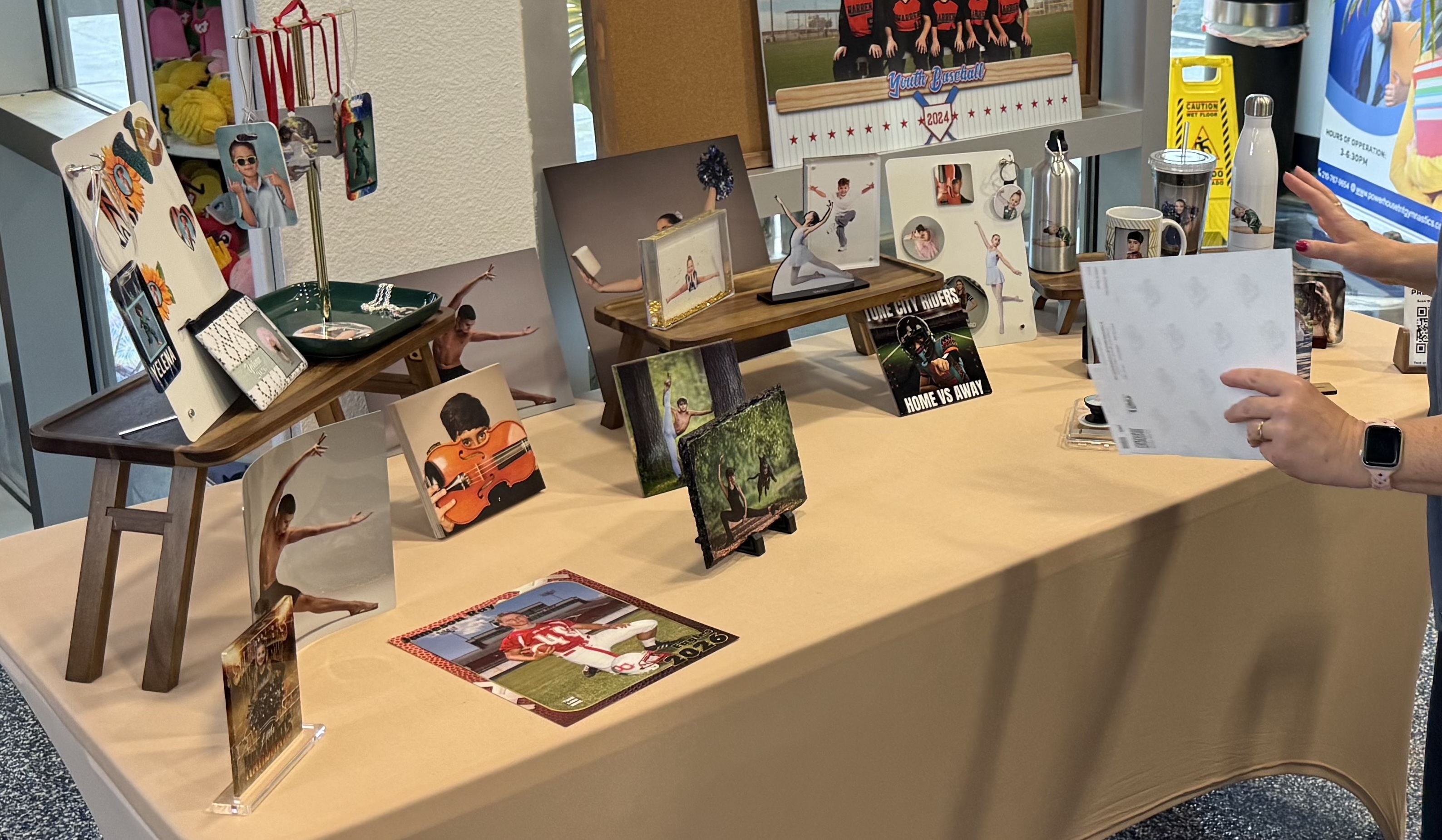 Picture day product display table with prints, composites, and sample products